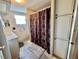 Bathroom featuring a vanity with sink, toilet, a patterned shower curtain, and ample storage space at 133 Hibiscus Way, Leesburg, FL 34748