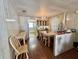 Traditional dining room featuring a table with chairs, wood floors, and access to the kitchen at 133 Hibiscus Way, Leesburg, FL 34748