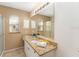 Bathroom featuring dual sinks, granite countertops, and a large mirror at 1402 Sanchez Ct, The Villages, FL 32159