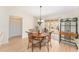 Dining area featuring a modern chandelier and sliding glass doors to the lanai at 1402 Sanchez Ct, The Villages, FL 32159