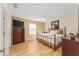 Cozy main bedroom with wood floors, a ceiling fan, and a large dresser at 1402 Sanchez Ct, The Villages, FL 32159