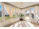 Bright sunroom with tile floors, neutral walls and large windows providing serene views and plenty of natural light at 1402 Sanchez Ct, The Villages, FL 32159