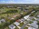 An aerial view of a home with a well-manicured lawn in a neighborhood with mature trees at 1417 E Schwartz Blvd, The Villages, FL 32159