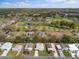 Aerial view showcasing the home's location near a golf course, pond, and green spaces at 1417 E Schwartz Blvd, The Villages, FL 32159