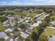 Aerial view of home in a tranquil neighborhood with verdant trees and lush green lawns at 1417 E Schwartz Blvd, The Villages, FL 32159