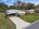 Aerial view showcasing a charming single-story home with mature landscaping at 1417 E Schwartz Blvd, The Villages, FL 32159