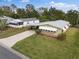 Aerial view showcasing a charming single-story home with mature landscaping at 1417 E Schwartz Blvd, The Villages, FL 32159