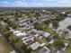 An aerial view of a well-maintained home near a beautiful lake in a serene neighborhood at 1417 E Schwartz Blvd, The Villages, FL 32159