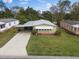 Aerial view showcasing a charming single-story home with mature landscaping at 1417 E Schwartz Blvd, The Villages, FL 32159