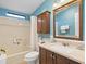 Bathroom featuring a shower/tub combo, storage cabinet, and blue walls at 1417 E Schwartz Blvd, The Villages, FL 32159