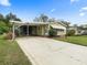 Charming single-story home featuring mature landscaping and a spacious driveway at 1417 E Schwartz Blvd, The Villages, FL 32159