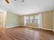 Well-lit living room with wood flooring, neutral walls, and sunlit windows at 1417 E Schwartz Blvd, The Villages, FL 32159