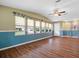 Bright, airy living room featuring wood floors, neutral paint, and ample natural light at 1417 E Schwartz Blvd, The Villages, FL 32159