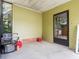 Enclosed patio featuring lawn care tools, a convenient space for outdoor maintenance and storage at 1417 E Schwartz Blvd, The Villages, FL 32159