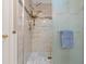 Updated shower with gray tile, decorative tile, and a glass shower door at 1417 E Schwartz Blvd, The Villages, FL 32159