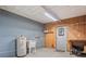 Utility room with a water heater, sink, and wall-mounted storage, providing functional space at 1417 E Schwartz Blvd, The Villages, FL 32159