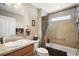 This bathroom is equipped with a granite countertop, a tub, and a shower with modern finishes at 1607 Quaker Ct, The Villages, FL 32163