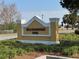 Community sign for Hillsborough Pool with nice landscaping surrounding the sign at 1607 Quaker Ct, The Villages, FL 32163