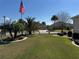 Well-manicured front yard featuring lush landscaping and a clear view of the house at 1607 Quaker Ct, The Villages, FL 32163