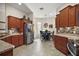 Well-lit kitchen and dining area featuring stainless steel appliances, mosaic backsplash and tile flooring at 1607 Quaker Ct, The Villages, FL 32163