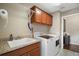 Laundry room featuring a utility sink, storage cabinets, and a newer washer and dryer at 1607 Quaker Ct, The Villages, FL 32163