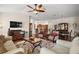 Bright living room featuring an open floor plan, a ceiling fan, and hardwood flooring at 1607 Quaker Ct, The Villages, FL 32163