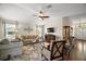 Cozy living room with hardwood floors, natural lighting, and a ceiling fan at 1607 Quaker Ct, The Villages, FL 32163