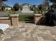 Back patio with a barbecue grill and partial view of neighborhood homes at 1607 Quaker Ct, The Villages, FL 32163