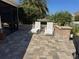 Back patio offering a relaxing outdoor space with seating and a view of the surrounding tropical landscaping at 1607 Quaker Ct, The Villages, FL 32163