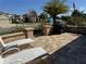 Outdoor patio area with chairs, a grill, and a partial view of the street and surrounding homes at 1607 Quaker Ct, The Villages, FL 32163