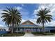 Exterior shot of the community recreation center with pretty landscaping at 1607 Quaker Ct, The Villages, FL 32163