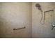 The tiled shower boasts a rainfall shower head, a handheld shower, and a convenient grab bar at 1607 Quaker Ct, The Villages, FL 32163