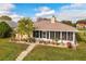 Backyard view of a single-story home with a screened-in porch and landscaped yard at 1739 Lake Villa Dr, Tavares, FL 32778