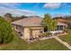 A well-maintained backyard featuring a small pergola and a variety of potted plants at 1739 Lake Villa Dr, Tavares, FL 32778