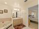 Bright bathroom featuring a soaking tub, vanity with a marble countertop, and a doorway leading to the Primary bedroom at 1739 Lake Villa Dr, Tavares, FL 32778