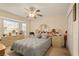 Cozy bedroom features a large window, ceiling fan, and decorative items at 1739 Lake Villa Dr, Tavares, FL 32778