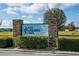 The 'Lake Saunders Pointe' entrance sign, framed by stone pillars and manicured hedges, welcomes you at 1739 Lake Villa Dr, Tavares, FL 32778