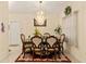 Formal dining room showcasing an elegant chandelier, wood table, and decorative rug at 1739 Lake Villa Dr, Tavares, FL 32778