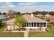 Well-maintained home featuring a charming screened-in porch, lush landscaping, and inviting curb appeal at 1739 Lake Villa Dr, Tavares, FL 32778