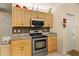 Kitchen featuring granite countertops, stainless steel appliances, and wooden cabinets at 1739 Lake Villa Dr, Tavares, FL 32778