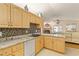 Kitchen featuring granite countertops, wooden cabinets, and an open layout into the living space at 1739 Lake Villa Dr, Tavares, FL 32778