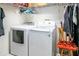 Laundry room with a full-size washer and dryer set and metal shelving at 1739 Lake Villa Dr, Tavares, FL 32778