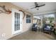 Enclosed sunroom with neutral paint, a ceiling fan, tiled floors, and cozy furnishings at 1739 Lake Villa Dr, Tavares, FL 32778