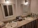 Bright bathroom featuring double sinks, modern fixtures, and decorative mirrors for added elegance at 1846 Fruitland Park Blvd, Fruitland Park, FL 34731