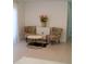 Cozy living room showcasing colorful accent chairs, a modern coffee table, and elegant floral decor at 1846 Fruitland Park Blvd, Fruitland Park, FL 34731