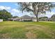 Sprawling backyard features mature trees, a lush green lawn, and a well-maintained landscape at 19215 Park Place Blvd, Eustis, FL 32736