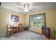 Bedroom with large window, ceiling fan, carpeted floor, and play area at 19215 Park Place Blvd, Eustis, FL 32736