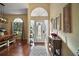 Inviting entryway featuring wood floors, a decorative rug, and natural light streaming through the front door at 19215 Park Place Blvd, Eustis, FL 32736