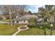 Beautiful single story home featuring mature landscaping, a circular garden, and a welcoming entrance at 19215 Park Place Blvd, Eustis, FL 32736