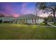 Charming home exterior with a sprawling lawn and a covered porch, perfect for outdoor relaxation at 19215 Park Place Blvd, Eustis, FL 32736